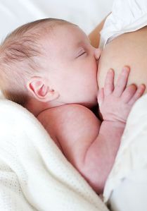 Newborn baby breastfeeding.