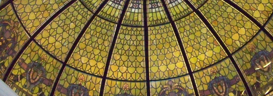 A stained-glass dome seen from below, every panel radiating out from a single center