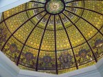 A stained-glass dome seen from below, every panel radiating out from a single center