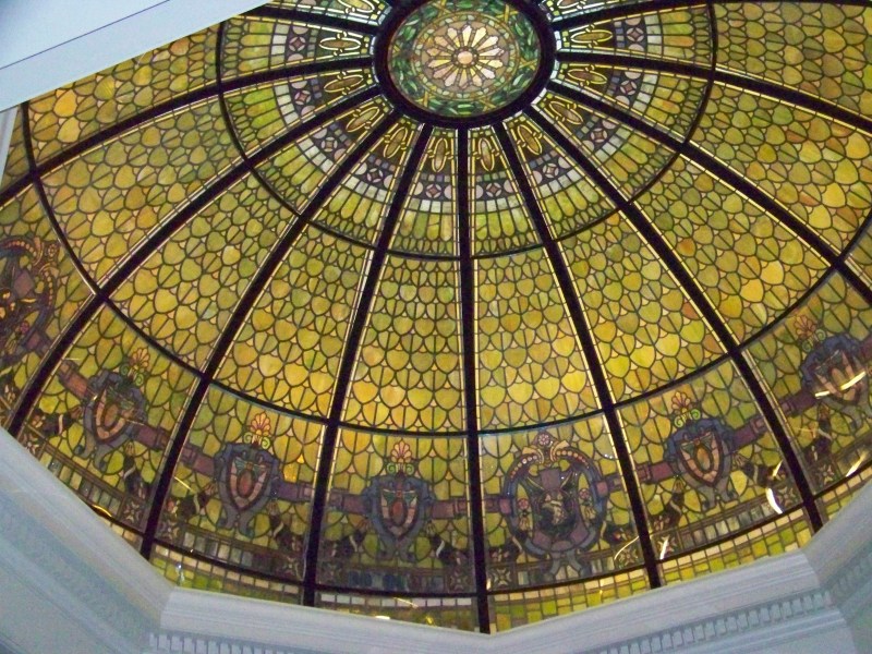 A stained-glass dome seen from below, every panel radiating out from a single center