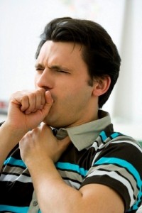 A man coughing into his fist