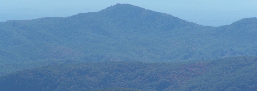 Layered blue ridges of the Blue Ridge Mountains with fall color in front