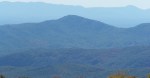 Layered blue ridges of the Blue Ridge Mountains with fall color in front