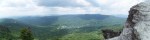 Panoramic view from Grandfather Mountain: ridge after ridge of the Blue Ridge fading into the distance above a green valley and lake